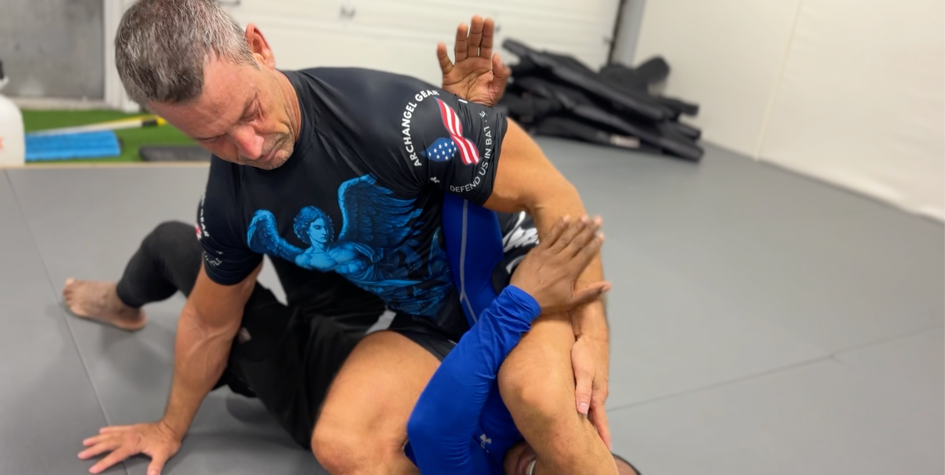 Grappling on the mat in Arkangel gear